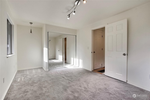 unfurnished bedroom featuring a closet and carpet floors