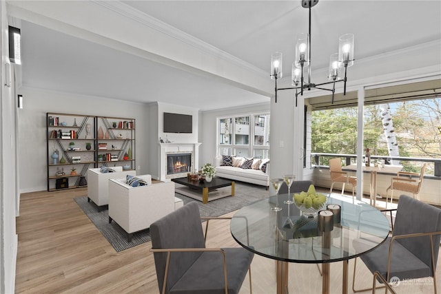 interior space with crown molding, light hardwood / wood-style floors, and an inviting chandelier