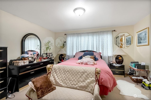 carpeted bedroom featuring multiple windows