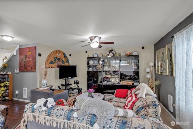 living room featuring hardwood / wood-style flooring and ceiling fan