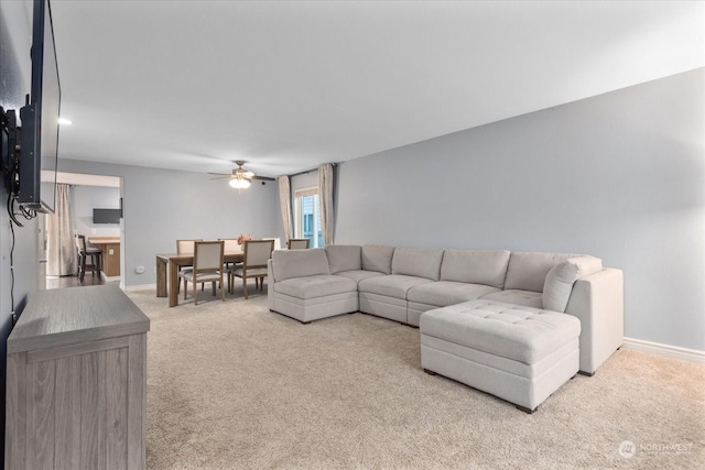 living room featuring light carpet and ceiling fan