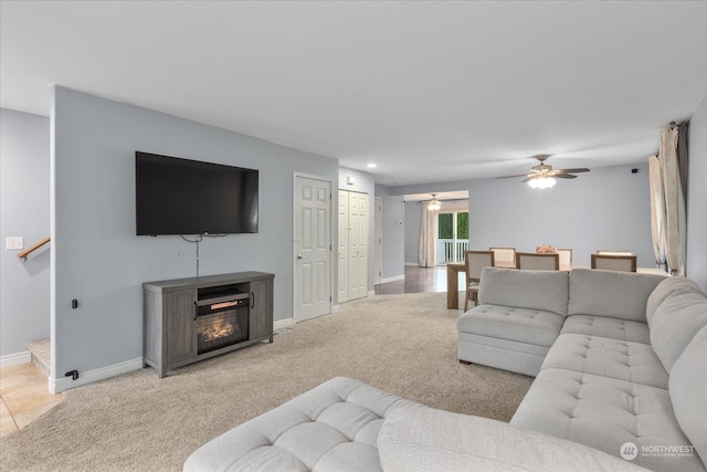 living room with ceiling fan and light colored carpet