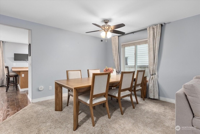 dining space with hardwood / wood-style flooring and ceiling fan