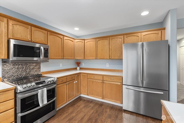 kitchen with decorative backsplash, dark wood-type flooring, and appliances with stainless steel finishes