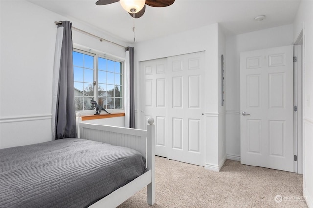 bedroom featuring ceiling fan and light carpet