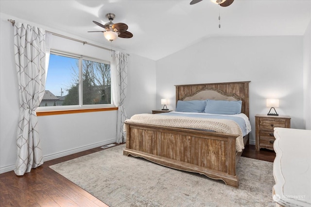 bedroom featuring ceiling fan, dark hardwood / wood-style floors, and lofted ceiling