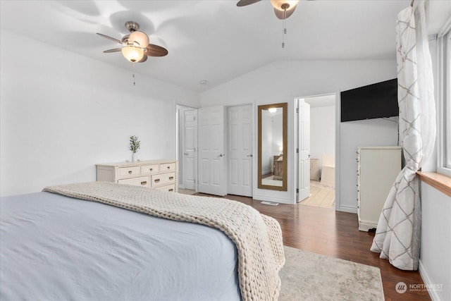 bedroom featuring dark hardwood / wood-style flooring, ceiling fan, and connected bathroom