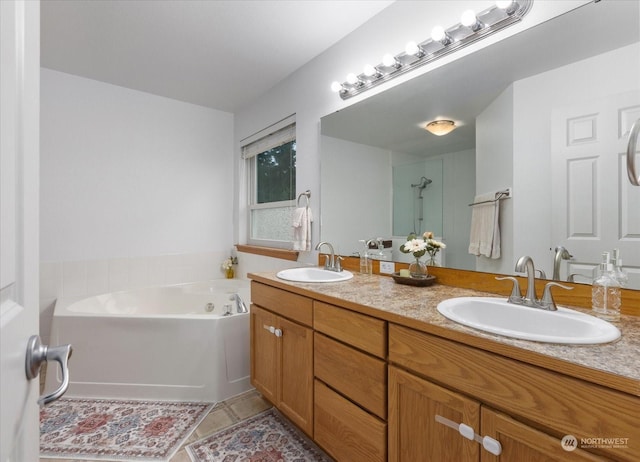 bathroom with tile patterned flooring, vanity, and a washtub