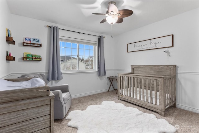 carpeted bedroom with a nursery area and ceiling fan