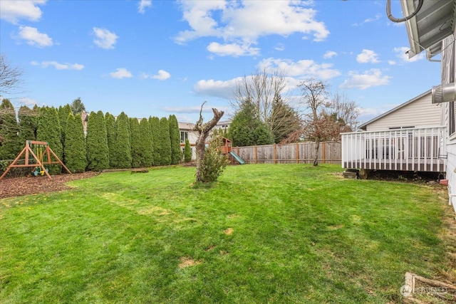 view of yard featuring a playground and a deck