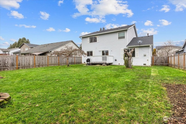 rear view of property with a lawn and a deck