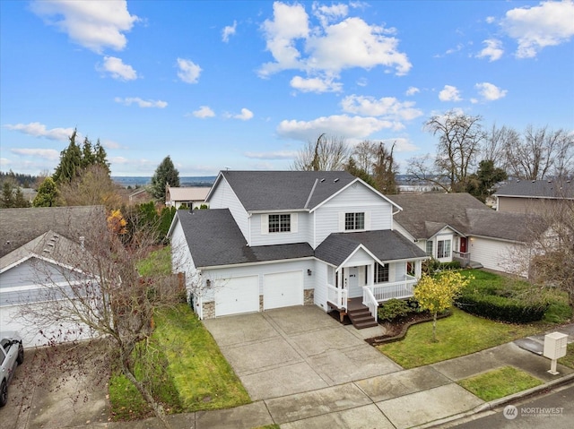 view of front property with a garage, covered porch, and a front lawn