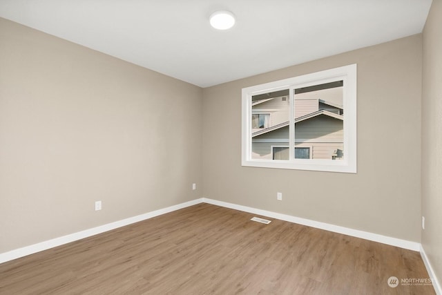 unfurnished room with wood-type flooring