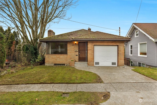 view of front facade with a front yard and a garage