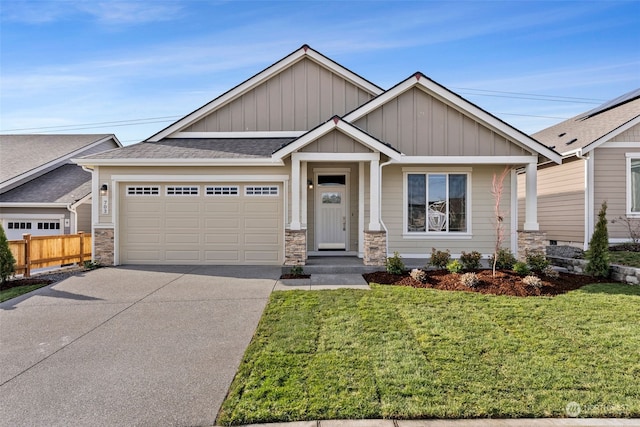 craftsman house featuring a garage and a front yard