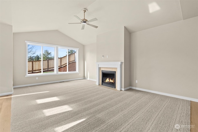 unfurnished living room featuring lofted ceiling, light colored carpet, and ceiling fan