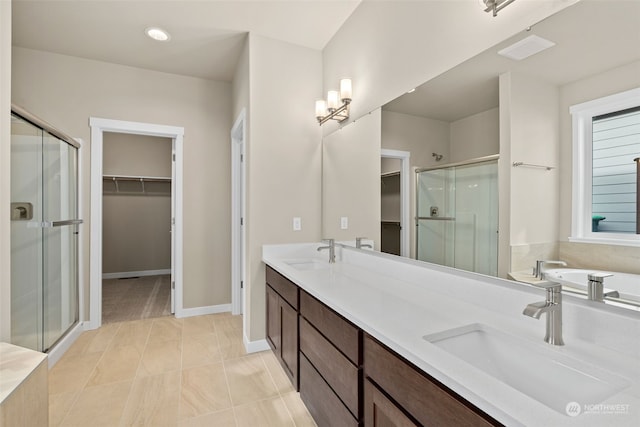 bathroom with an enclosed shower, vanity, and tile patterned flooring