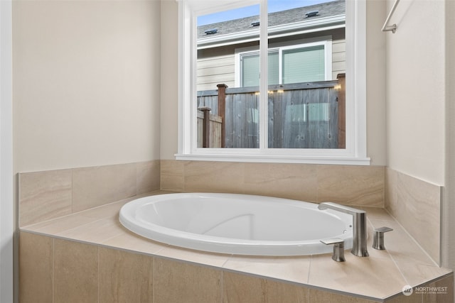 bathroom featuring a relaxing tiled tub