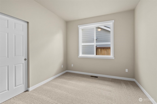 unfurnished room featuring carpet