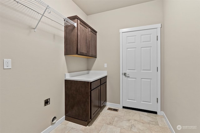 laundry room featuring cabinets and electric dryer hookup