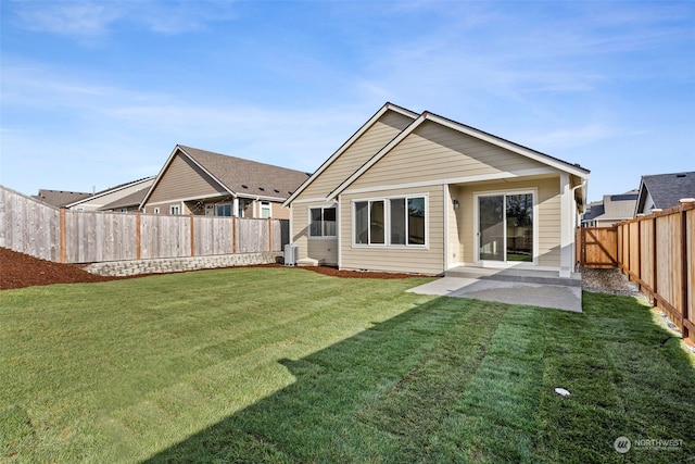 rear view of property with a yard and a patio