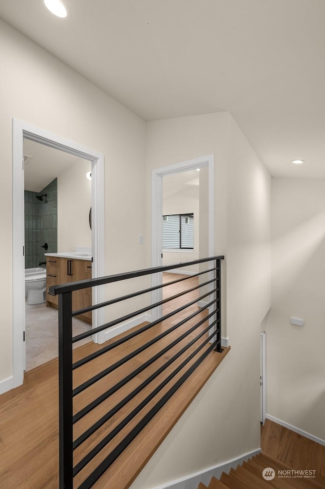 stairway with wood-type flooring and vaulted ceiling