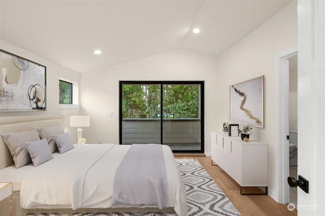 bedroom featuring light hardwood / wood-style floors, access to outside, and vaulted ceiling