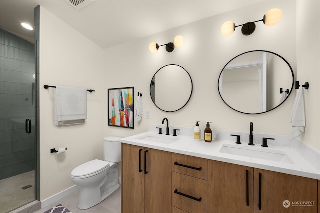 bathroom featuring tile patterned floors, vanity, a shower with shower door, and toilet