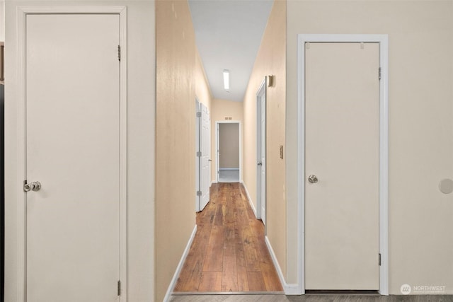 corridor featuring wood-type flooring