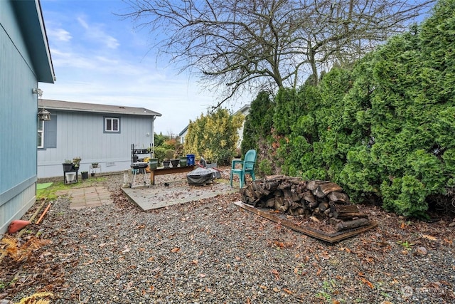 view of yard featuring a patio area and an outdoor fire pit