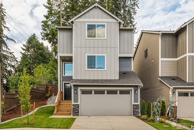 view of front facade featuring a front yard and a garage