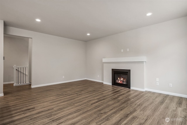 unfurnished living room featuring dark wood-type flooring