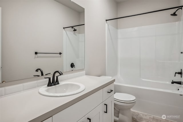 full bathroom with tile patterned floors, toilet, vanity, and washtub / shower combination