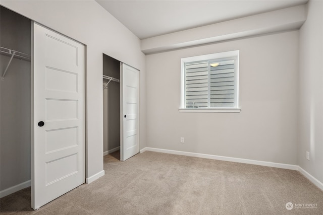 unfurnished bedroom with light colored carpet