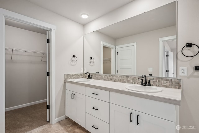 bathroom with backsplash, tile patterned floors, and vanity