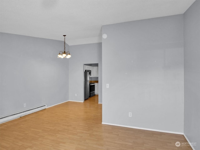 unfurnished room with baseboard heating, light wood-type flooring, and an inviting chandelier