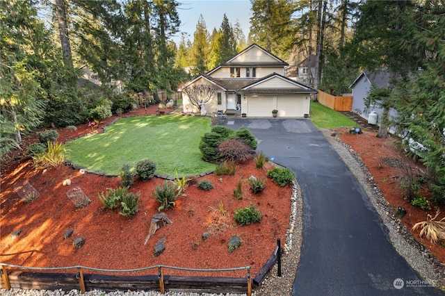 view of front of home with a garage and a front lawn