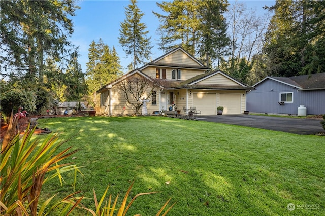 view of property with a front lawn and a garage