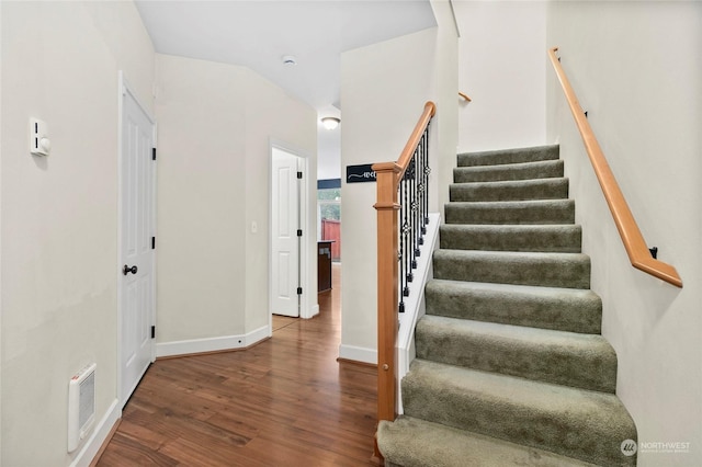 staircase with wood-type flooring