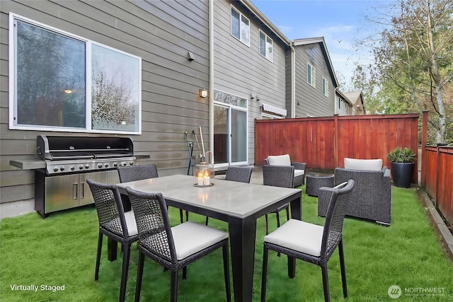 view of patio / terrace featuring outdoor dining area, fence, and a grill