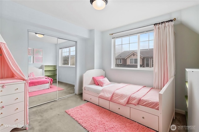 carpeted bedroom with baseboards and a closet