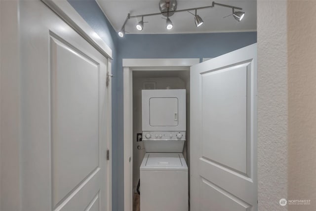 laundry area featuring stacked washer and dryer