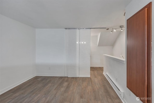 empty room featuring dark hardwood / wood-style flooring and baseboard heating