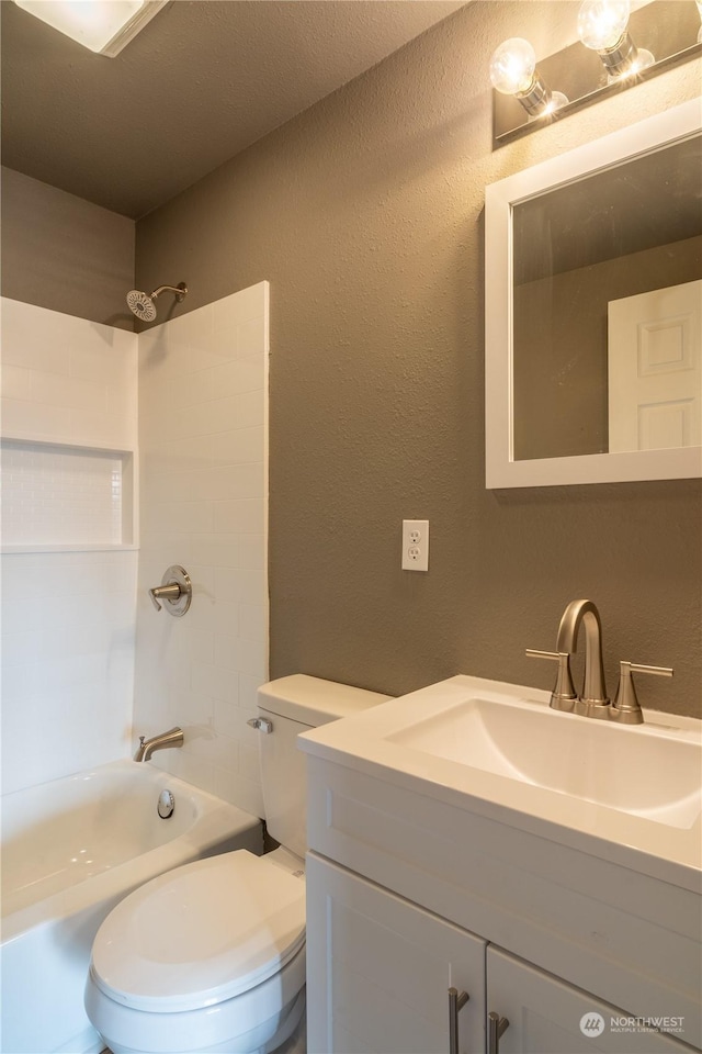 full bathroom featuring bathtub / shower combination, a textured ceiling, vanity, and toilet