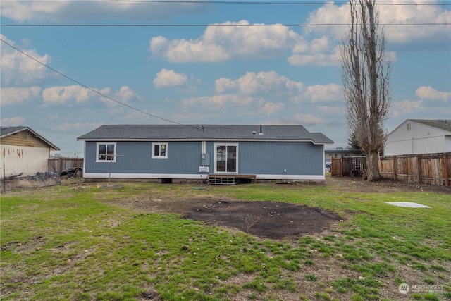 back of house featuring a lawn