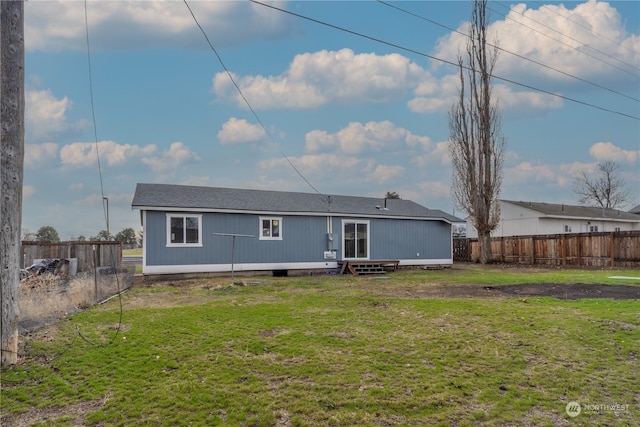 rear view of property with a lawn