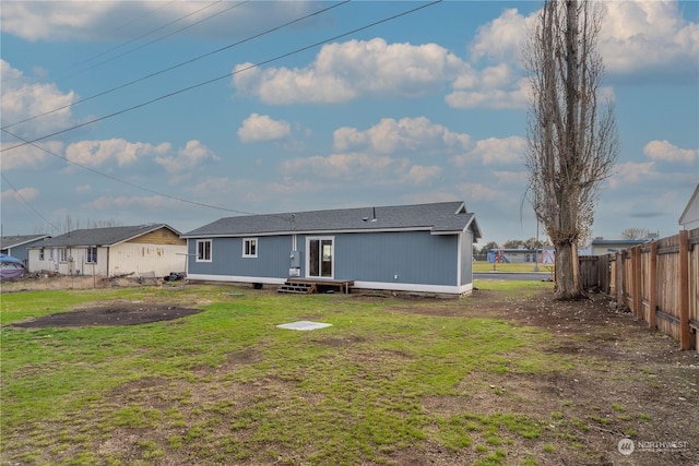 back of house with a yard