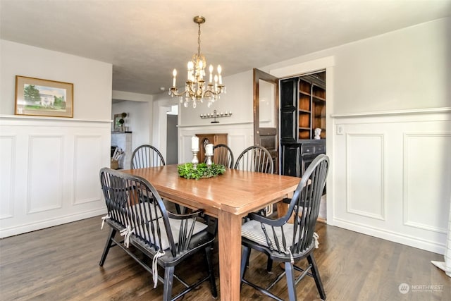 dining area featuring dark hardwood / wood-style flooring and a chandelier