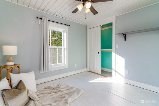 bedroom with ceiling fan, light hardwood / wood-style floors, wood ceiling, and a closet