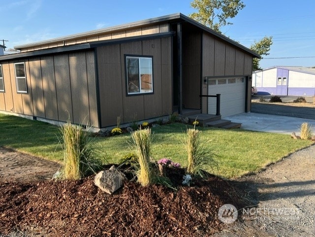 view of side of home featuring a yard and a garage